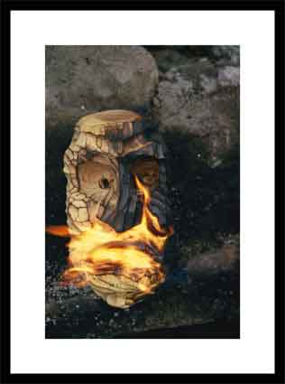 A wooden mask is set on fire
